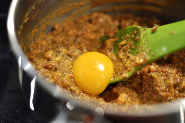 Adding egg yolk to meat mixture