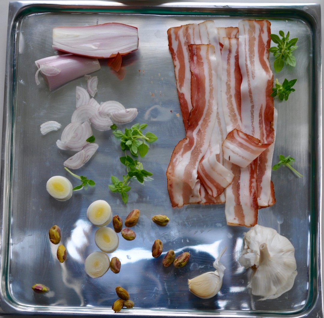 Chicken ballotine wrapped in pancetta, with pistachios and leek